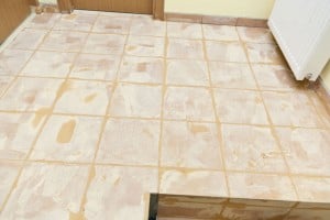 Grouting floor tiles