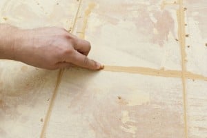 Grouting floor tiles