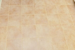 Grouting floor tiles