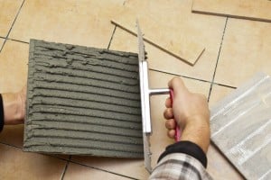 Spreading adhesive on tile Spreading adhesive on tile